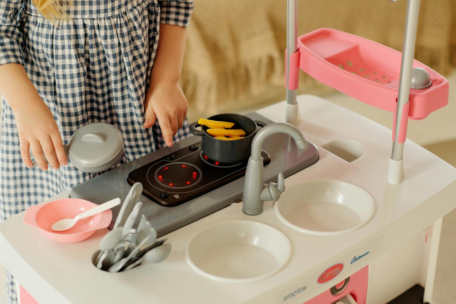 Girl playing with a kitchen toy
